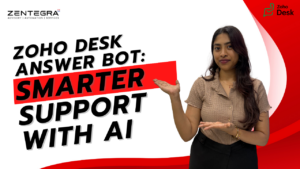 A Zentegra consultant gesturing toward text that reads “Zoho Desk Answer Bot: Smarter Support with AI” on a white and red business-themed background.