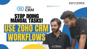 Two professionals using laptop demonstrating Zoho CRM workflows to automate manual business tasks